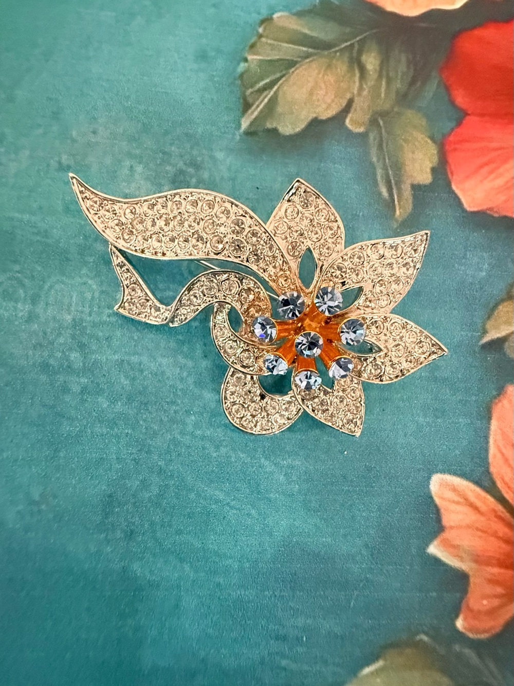 Elegant Silver-Tone Floral Crystal Brooch with Blue and Amber Accents